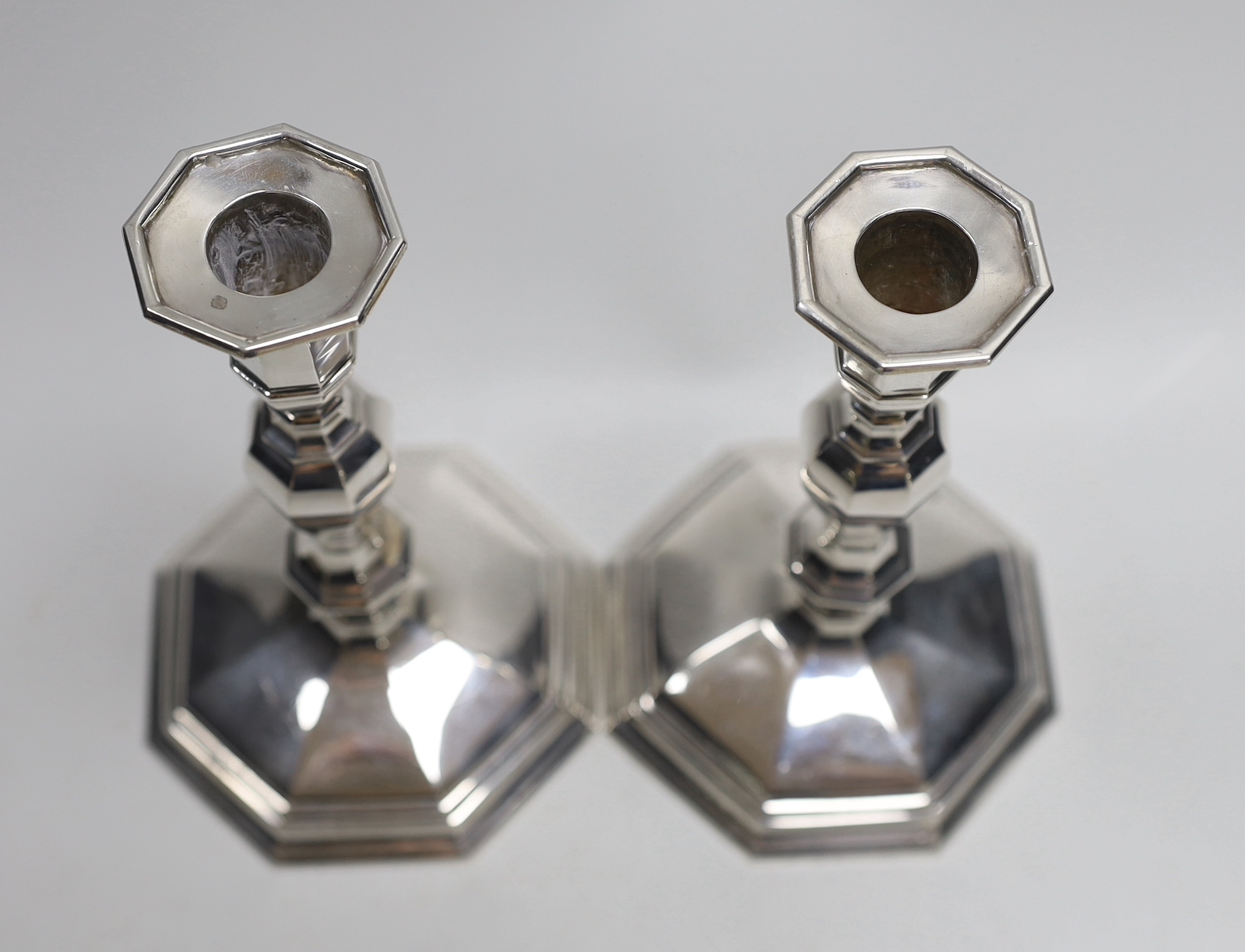 A pair of Queen Elizabeth II cast silver candlesticks, on octagonal bases, H&R, London, 1994, height 17.3cm, 30.9oz.